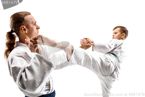 Image of Man and teen boy fighting at aikido training in martial arts school