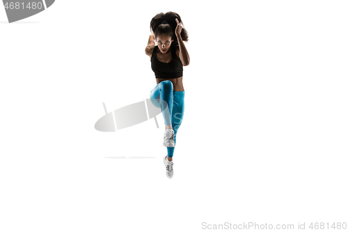 Image of Young african woman running or jogging isolated on white studio background.