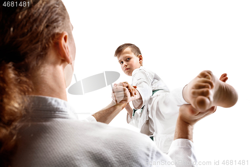 Image of Man and teen boy fighting at aikido training in martial arts school