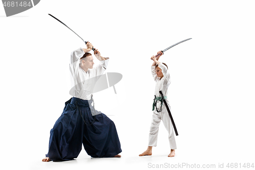 Image of Man and teen boy fighting at aikido training in martial arts school