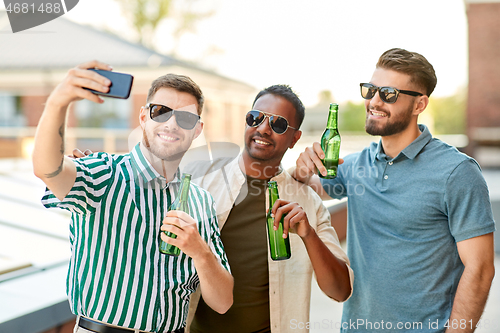 Image of men drinking beer and taking selfie by smartphone