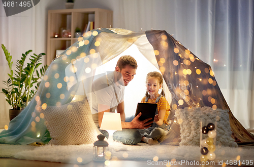 Image of family with tablet pc in kids tent at home