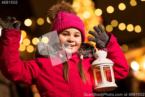 Image of happy little girl at christmas with lantern market