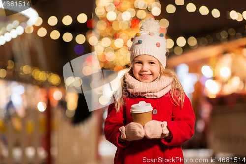 Image of happy girl with cup of tea at christmas market