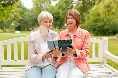 Image of senior women with tablet pc at summer park