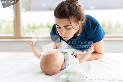 Image of mother with baby daughter at home
