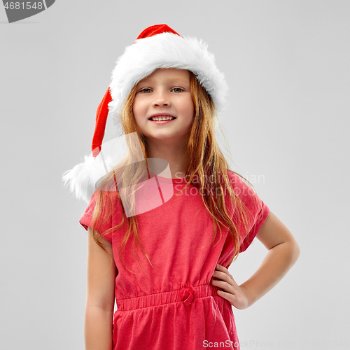 Image of smiling red haired girl posing in snata helper hat