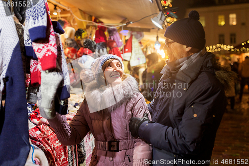 Image of senior couple at christmas market clothing shop