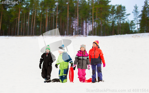 Image of happy little kids with sleds in winter