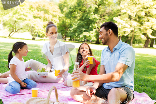 Image of happy family having picnic at summer park