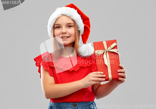 Image of smiling girl in snata hat with christmas gift