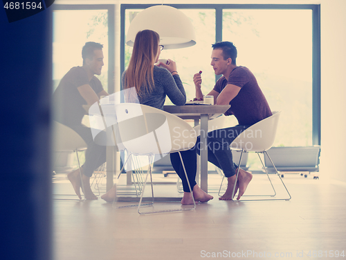 Image of couple enjoying morning coffee and strawberries