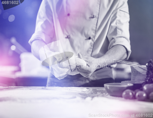 Image of chef hands preparing dough for pizza