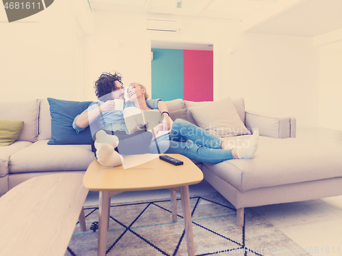 Image of Young couple on the sofa watching television