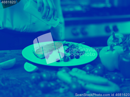 Image of Chef finishing steak meat plate