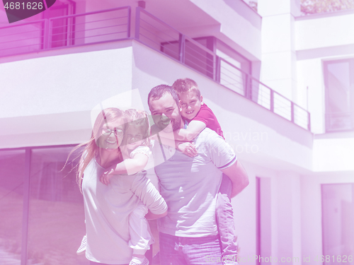 Image of happy family with children in the yard