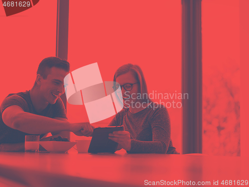 Image of couple enjoying morning coffee and strawberries