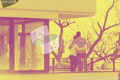 Image of couple enjoying morning coffee on balcony