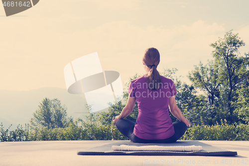 Image of handsome woman doing morning yoga exercises