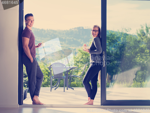 Image of couple on the door of their luxury home villa