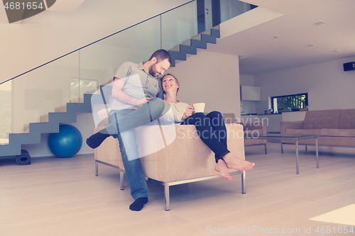 Image of romantic couple on the sofa watching television