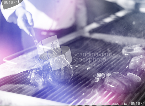 Image of chef cooking steak with vegetables on a barbecue