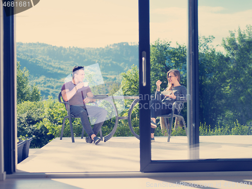 Image of couple enjoying morning coffee and breakfast