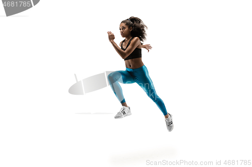 Image of Young african woman running or jogging isolated on white studio background.