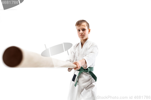 Image of Teen boy fighting with wooden sword at Aikido training in martial arts school