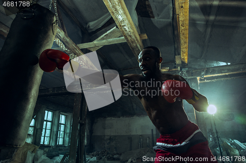 Image of Hand of boxer over black background. Strength, attack and motion concept