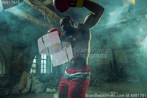 Image of Hand of boxer over black background. Strength, attack and motion concept