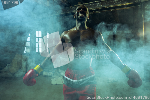 Image of Hand of boxer over black background. Strength, attack and motion concept