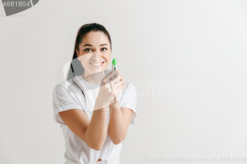 Image of Smiling young woman looking on pregnancy test