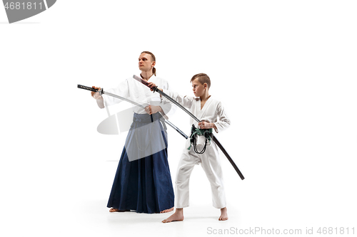 Image of Man and teen boy fighting at aikido training in martial arts school