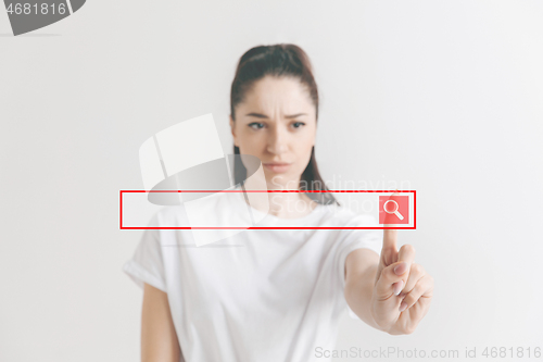 Image of Woman\'s hand with finger on gray background