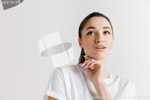 Image of Young serious thoughtful business woman. Doubt concept.