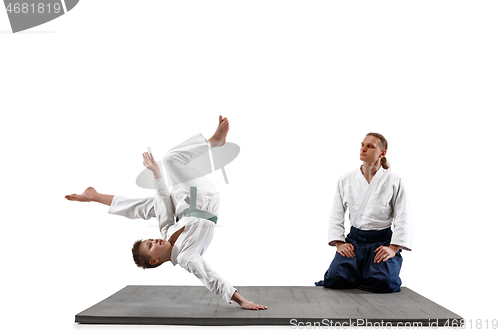 Image of Man and teen boy fighting at aikido training in martial arts school