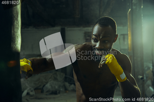 Image of Hand of boxer over black background. Strength, attack and motion concept