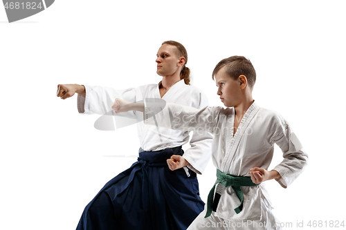 Image of Man and teen boy fighting at aikido training in martial arts school