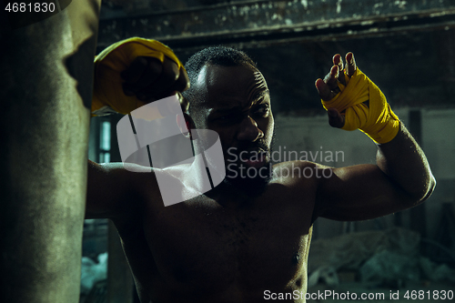 Image of Hand of boxer over black background. Strength, attack and motion concept