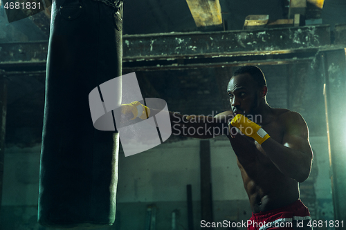 Image of Hand of boxer over black background. Strength, attack and motion concept