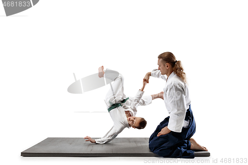 Image of Man and teen boy fighting at aikido training in martial arts school