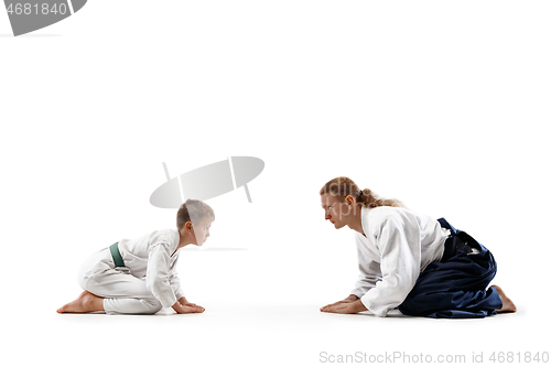 Image of Man and teen boy at aikido training in martial arts school