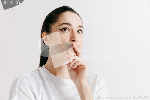 Image of Young serious thoughtful business woman. Doubt concept.