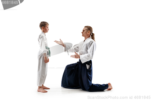 Image of Man and teen boy fighting at aikido training in martial arts school