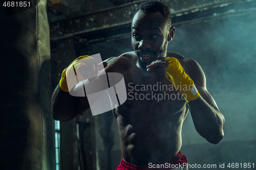 Image of Hand of boxer over black background. Strength, attack and motion concept