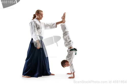 Image of Man and teen boy fighting at aikido training in martial arts school