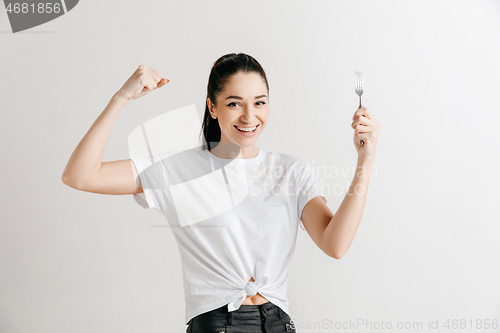 Image of Young fun crazy brunette housewife with fork isolated on white background