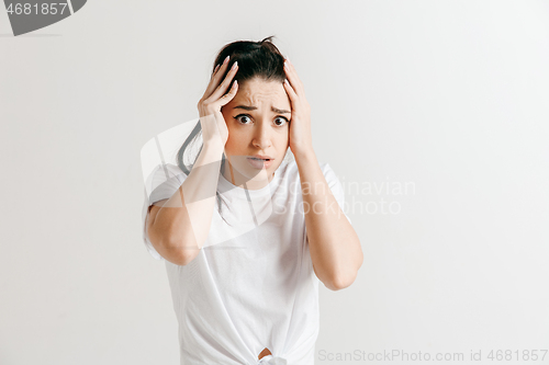 Image of Woman having headache. Isolated over gray background.