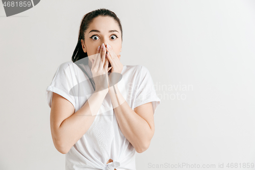 Image of Portrait of the scared woman on gray